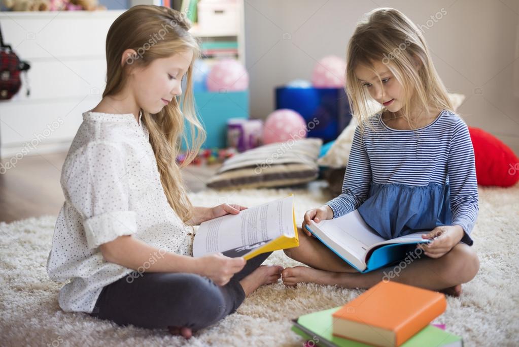 Two girls studying and reading Stock Photo by ©gpointstudio 96507030